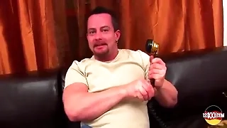 A girl is caressing a huge dick with her mouth